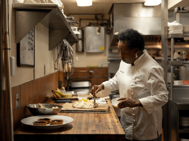 Dolester Miles brushes egg wash onto an apple crostata in the kitchen of Bottega. (Rob Culpepper/For The Washington Post)
