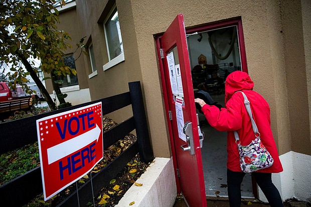 A woman arrives to vote at Philomont Fire Station, in Purcellville, Virginia