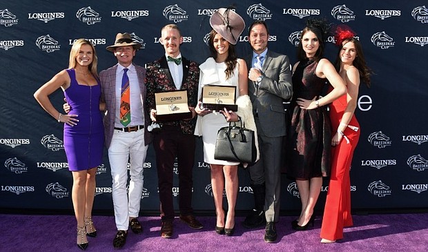 Mattias Dylan Horseman, center left, of Austin, Texas, and McKenzie Marcinek, center right, of Lexington, Kentucky, pose with judges Jane Motion, daughter of Kentucky Derby-winning trainer Graham Motion, TV personality Carson Kressley, Pascal Savoy, Brand President for Longines U.S., Bri Mott, of Fashion at the Races, and Sophie Flay, daughter of Bobby Flay, after they won the Longines Prize for Elegance contest at the 2018 Breeders' Cup, Saturday, Nov. 3, 2018, at Churchill Downs in Louisville, KY.