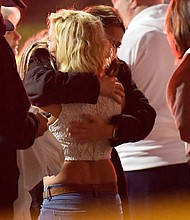 People comfort each other near the scene Thursday in Thousand Oaks, Calif.