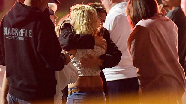 People comfort each other near the scene Thursday in Thousand Oaks, Calif.