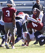 Virginia Union University’s Olu Izegwire, a senior wide receiver in the No. 4 jersey, gets pounded as he powers into the end zone during last Saturday’s game against the Virginia State University Trojans at Hovey Field in Richmond.