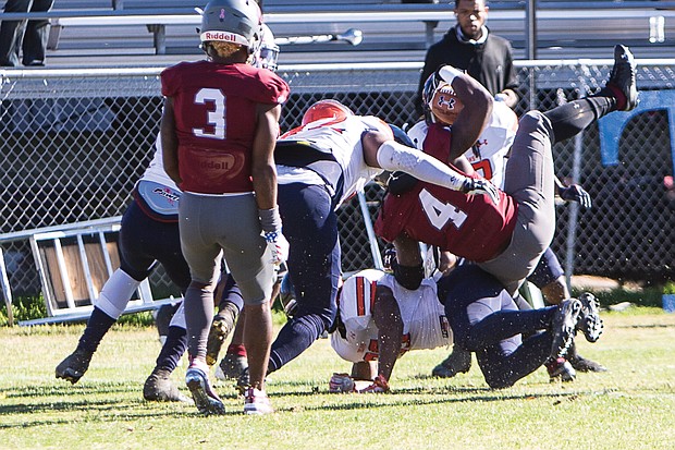 Virginia Union University’s Olu Izegwire, a senior wide receiver in the No. 4 jersey, gets pounded as he powers into the end zone during last Saturday’s game against the Virginia State University Trojans at Hovey Field in Richmond.