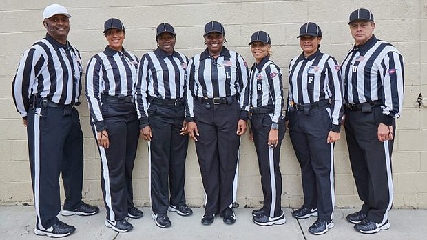 The all-female officials team, plus referee Elbert Lassiter (far right) and umpire Leonard VanHoose (far left),