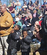 Armistice Day: Martene Whiting Jr.’s parents, Martene and Samantha Whiting, above, both Air Force veterans, stand as the crowd recognizes them during the ceremony. Clapping for their older brother are Emmanuel, 7, and Danuel, 5. (Regina H. Boone/Richmond Free Press)