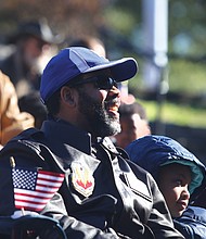 Commissioner John L. Newby II, with the Department of Veteran Services of the Commonwealth of Virginia participates in the Commonwealth's Veterans Day ceremony at Dogwood Dell Sunday , Nov. 11, 2018, the 100th anniversary of Armistice Day with his daughter Jillian Newby, 9, both of Henrico County. 
(Regina H. Boone/Richmond Free Press)