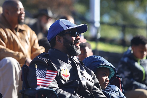 Commissioner John L. Newby II, with the Department of Veteran Services of the Commonwealth of Virginia participates in the Commonwealth's Veterans Day ceremony at Dogwood Dell Sunday , Nov. 11, 2018, the 100th anniversary of Armistice Day with his daughter Jillian Newby, 9, both of Henrico County. 
(Regina H. Boone/Richmond Free Press)