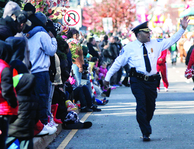 Chief Durham waves to the crowd as he takes part in Richmond’s 2015 Christmas Parade. In typical fashion, he is walking, rather than riding, along the two-mile route.