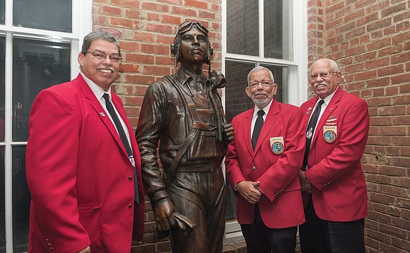 From left, brothers Richard, David and Howard Baugh stand with the life-size bronze statue of their late father, Lt. Col. ...
