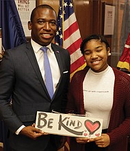 Mayor Levar M. Stoney presents Binford Middle School student Jalia Hardy with a handmade sign after signing a proclamation declaring Nov. 12 through 16 “Kindness Week” in Richmond.