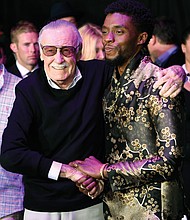 Comic book artist, Stan Lee, left, creator of the “Black Panther” superhero character, greets actor and star of the “Black Panther” movie Chadwick Boseman at the film’s Jan. 29 premiere at The Dolby Theatre in Los Angeles.