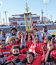 Players and coaches with the Richmond Parks and Recreation 2018 Champion Reid Ravens celebrate after defeating the Hotchkiss Eagles 18-0 in the 10U Peewee division last Saturday at City Stadium.