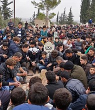 Mourners attend the funeral of Raed al-Fares and his friend Hamud al-Juneid in Idlib.