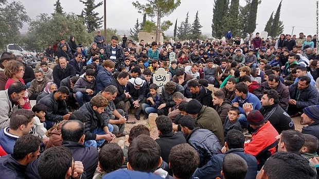 Mourners attend the funeral of Raed al-Fares and his friend Hamud al-Juneid in Idlib.