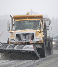 A plow clears snow from in Douglas County, Kansas, Sunday.