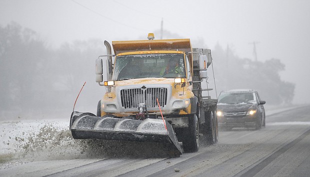 A plow clears snow from in Douglas County, Kansas, Sunday.