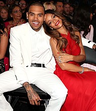 Apparently risqué photos of Rihanna are enough to grab Chris Brown's attention.