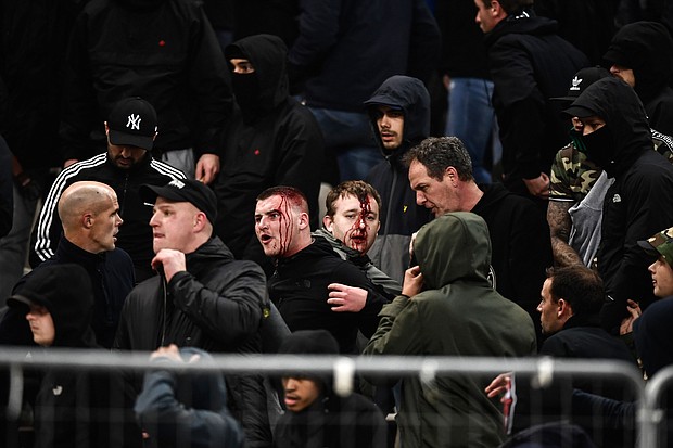 Ajax supporters were left bloodied in clashes before the team's game at AEK Athens in the Champions League.