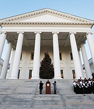Gov. Ralph S. Northam and First Lady Pamela Northam light the official Virginia Capitol Christmas tree that stands on the South Portico of the Capitol. Participating in the ceremony Wednesday night are the Eastern View High School Troubadors from Culpeper County and Bettina Ring, state secretary of agriculture and forestry. The tree lighting touches off many of the area’s holiday festivities that will take place Friday and Saturday.