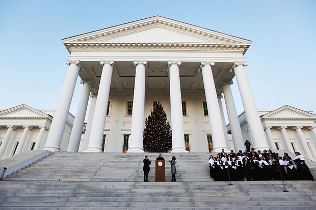 Gov. Ralph S. Northam and First Lady Pamela Northam light the official Virginia Capitol Christmas tree that stands on the South Portico of the Capitol. Participating in the ceremony Wednesday night are the Eastern View High School Troubadors from Culpeper County and Bettina Ring, state secretary of agriculture and forestry. The tree lighting touches off many of the area’s holiday festivities that will take place Friday and Saturday.