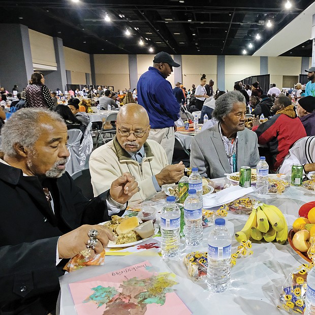 Giving thanks: Hundreds of people enjoyed a sumptuous dinner on Thanksgiving Day at The Giving Heart Community Thanksgiving Feast at the Greater Richmond Convention Center in Downtown. The annual event is free and draws hundreds of volunteers and contributors who provide fellowship and service to families and individuals sitting down for dinner. Among those enjoying the food are, top from left, Harry Howell, Henry Munford, Royal Munford, Mary Singh and Josephine Munford. Behind the scenes, volunteers are hard at work preparing plates with turkey and all the fixings. (Sandra Sellars/Richmond Free Press)
