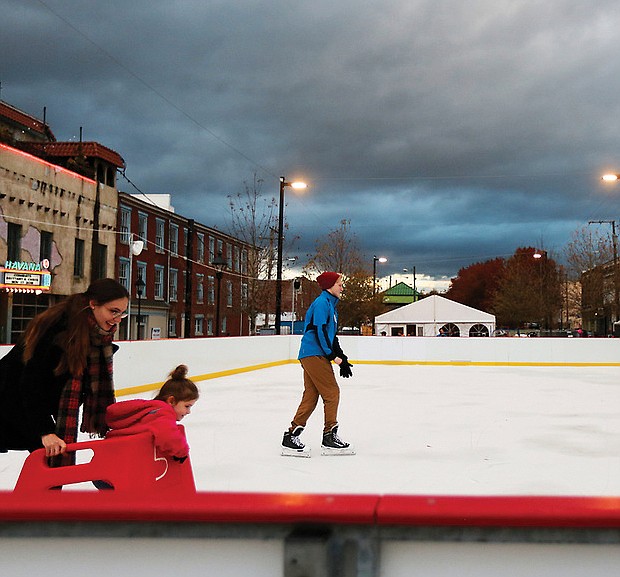 Krista Waddell, left, and her 5-year-old daughter, Aribella, get ready to join Ian Donselaar, 18, center, on RVA On Ice’s skating rink located at the 17th Street Farmers’ Market near Main Street Station. Sponsored by Capital One, the rink quietly opened just before Thanksgiving at its new location. It’s official opening will be Friday, Dec. 1. The rink will be open seven days a week before wrapping up the season on Monday, Jan. 21, Martin Luther King Day. “Rock the Rink” parties are scheduled for 8 to 10 p.m. Saturday nights in December and January. On most days, the rink and skate rental tent open at 3 p.m.; however, skating begins at 11 a.m. on Saturdays and Sundays. Details: (804) 234-3905 or https://enrichmond.org/17th-street-market/rva-on-ice. (Regina H. Boone/Richmond Free Press )