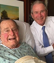 Former President George H.W. Bush pictured with his son, former President George W. Bush, during a hospital visit.
