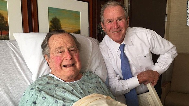 Former President George H.W. Bush pictured with his son, former President George W. Bush, during a hospital visit.