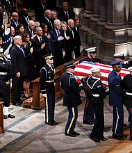The flag-draped casket of former President George H.W. Bush is carried into Washington National Cathedral on Wednesday by military pallbearers past his son, left, former President George W. Bush, and in the pew at right, President Trump and First Lady Melania Trump; former President Barack Obama and Michelle Obama; former President Bill Clinton and Hillary Clinton; and former President Jimmy Carter and Rosalynn Carter.