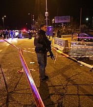 Israeli security forces and emergency personnel work at the scene in Ofra.