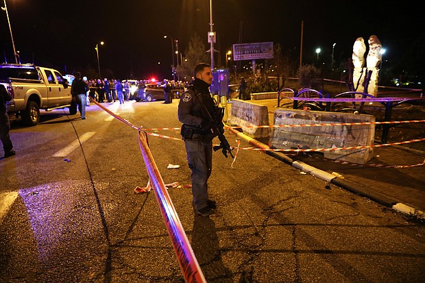 Israeli security forces and emergency personnel work at the scene in Ofra.