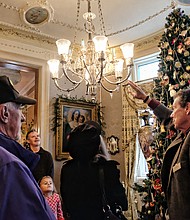 Old-fashioned Christmas: Visitors to Maymont embraced the holiday spirit last Sunday with the park’s annual Old-fashioned Christmas celebration. A group gathers near the 12-foot Christmas tree and its Victorian decorations during a tour of the Dooley Mansion. The Gilded-Age mansion will be decked out for holiday tours through Jan. 6  (Sandra Sellars/Richmond Free Press)