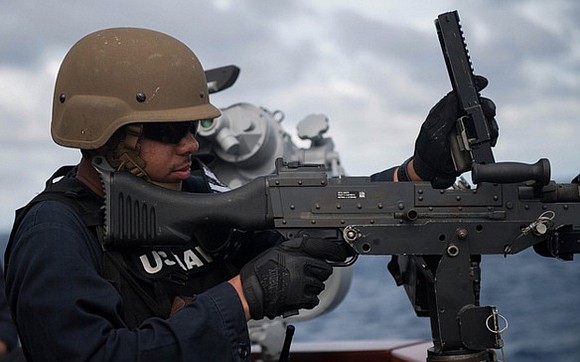 U.S. Navy Gunner’s Mate 2nd Class Kimani Williams, from Houston, reloads an M240 machine gun during a live-fire exercise aboard …