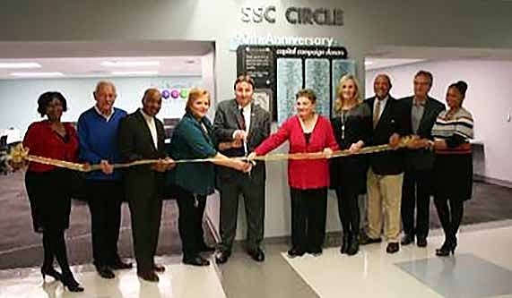 Pictured with Scissors: South Suburban College’s Robin Rihacek, Executive Director of Enrollment & Retention Services and Frank Zuccarelli, Chairman of the Board of Trustees, cut the ribbon to officially open SSC Circle, a new student assistance facility at the college’s Main Campus in South Holland