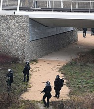 French special forces search a bank of the River Rhine in Strasbourg on Wednesday as they hunt the gunman.