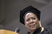 Virginia Commonwealth University fall commencement speaker Christy Coleman offers graduates words of advice during a ceremony last Saturday at the Siegel Center. Left, graduates celebrate their new degrees during the ceremony.