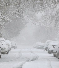 A wind-blown blanket of snow covers the parked cars and pavement on a North Side street. The wintry scene is just one example of the impact of Sunday’s storm that dropped nearly a foot of snow on the area — the largest amount on record for Metro Richmond for a snowfall prior to Dec. 10, and the second largest snowfall for December since 1908. (Regina H. Boone/Richmond Free Press)