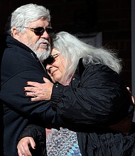 Susan Bro, mother of 32-year-old paralegal Heather Heyer, hugs her husband, Kent Bro, on the steps of the Charlottesville courthouse Tuesday after a jury recommended that the avowed neo-Nazi who killed her daughter in August 2017 spend the rest of his life in prison.