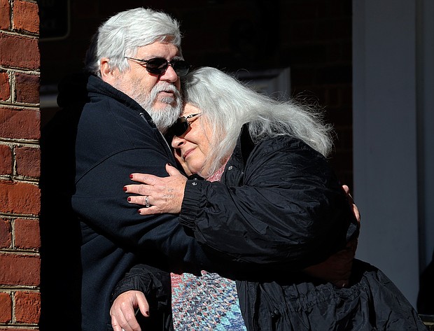 Susan Bro, mother of 32-year-old paralegal Heather Heyer, hugs her husband, Kent Bro, on the steps of the Charlottesville courthouse Tuesday after a jury recommended that the avowed neo-Nazi who killed her daughter in August 2017 spend the rest of his life in prison.