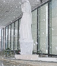 Brrrrr! The first snowfall of the season last Sunday resulted in people heading outdoors in the cold to clear snowy walkways and parking spots so that people and cars could safely maneuver. The marble statue at the Virginia War Memorial stands in contrast to the falling snowflakes. (Regina H. Boone/Richmond Free Press)