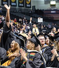 Virginia Commonwealth University fall commencement speaker Christy Coleman offers graduates words of advice during a ceremony last Saturday at the Siegel Center. Graduates celebrate their new degrees during the ceremony.