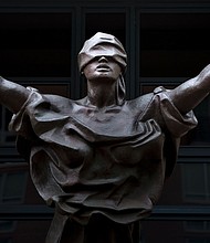 A statue of Justice at the Albert V. Bryan United States Courthouse in Alexandria, Virginia