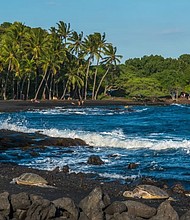 The charcoal-hued beach boasts plenty of vivid scenery. Cross the beach to find a section of the 175-mile Ala Kahakai Trail.