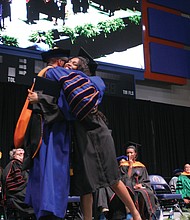 VSU President Makola M. Abdullah gives a congratulatory hug to his daughter, Sefiyetu, who received her bachelor’s in mass communications during the ceremony.