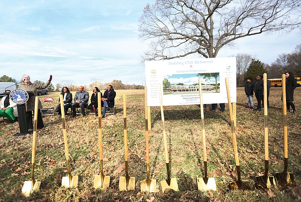 Above, School Board member Linda Owen, 9th District, addresses a small group attending the ceremony on the site of the former Elkhardt Middle School at 6300 Hull St. Road, while, right, Rose Ferguson, principal at George Mason Elementary School in the East End, hugs Superintendent Jason Kamras during that ceremony. All three schools are to be completed by the fall of 2020.