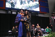 VSU President Makola M. Abdullah gives a congratulatory hug to his daughter, Sefiyetu, who received her bachelor’s in mass communications during the ceremony.