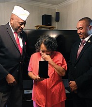 Towanda C. Lee of Mechanicsville cries as she and her brother, Damon R. Charity, right, receive the Congressional Gold Medal on behalf of their father, the late Sgt. Herman Russell Charity Sr., who was one of the nation’s Montford Point Marines. Retired Master Sgt. Forest E. Spencer Jr., left, presented the award in October.