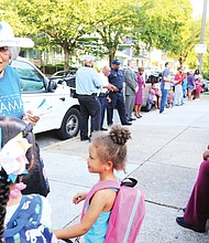 Ruth R. Little, a retired teacher, greets students on their first day of classes at the newly named Obama Elementary School on Fendall Avenue in North Side in September.