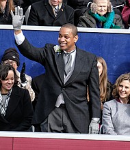 Lt. Gov. Justin E. Fairfax waves to a cheering crowd after taking the oath of office in January. He is only the second African-American to be elected to statewide office in Virginia. His wife, Dr. Cerina Fairfax, a dentist, is seated next to him with Attorney General Mark Herring and First Lady Pam Northam and Gov. Ralph S. Northam, right.