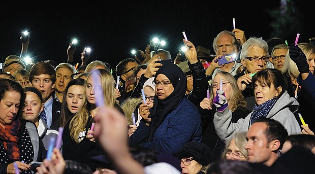 Hundreds of people of different faiths, races and backgrounds raise lights of hope in a show of unity and love during a vigil at the Weinstein Jewish Community Center on Monument Avenue in October following a mass shooting at the Tree of Life Synagogue in Pittsburgh in which 11 people were killed.